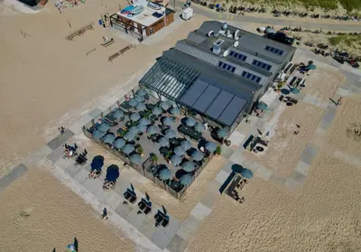 an overhead view of a building on the beach at overnachtingopstrand in Katwijk