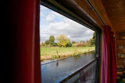 a view of a river from a train window at Houseboat Vinkeveen in Vinkeveen