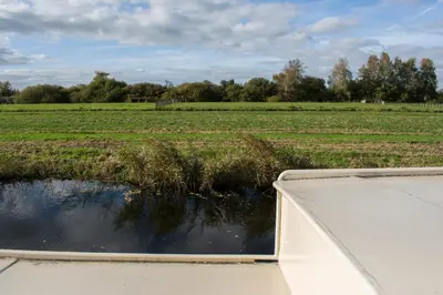 a view of a field from the back of a boat at Houseboat Vinkeveen in Vinkeveen