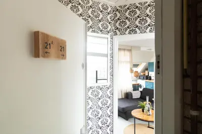 a living room with blue and white wallpaper at Strand appartement aan zee met 2 parkeerplekken! in Egmond aan Zee