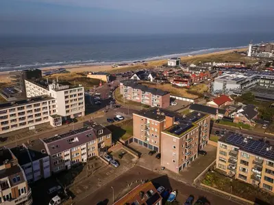 an aerial view of a city and the ocean at Strand appartement aan zee met 2 parkeerplekken! in Egmond aan Zee
