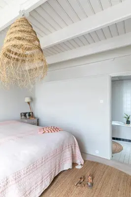 a bedroom with a bed and a large chandelier at Villa Magnolia in Bergen