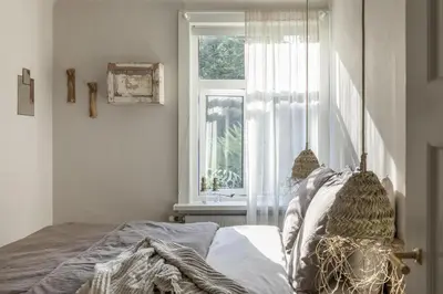 a bedroom with a bed and a window at Villa Magnolia in Bergen