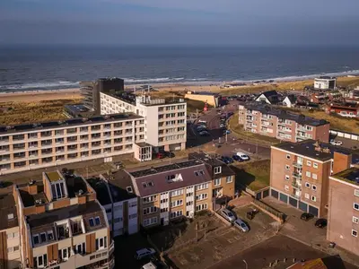 an aerial view of a city and the ocean at Knus appartement met parkeerplek en zeezicht! in Egmond aan Zee