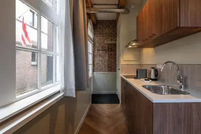 a kitchen with a sink and a window at Studio Urbain by Grapèlli Boutique Hotel in Alkmaar