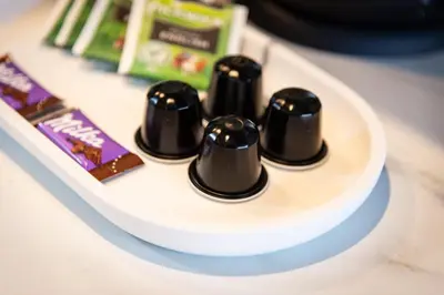 a group of three black things on a white plate at Studio Urbain by Grapèlli Boutique Hotel in Alkmaar