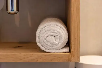 a roll of towels sitting on a shelf in a bathroom at Studio Urbain by Grapèlli Boutique Hotel in Alkmaar