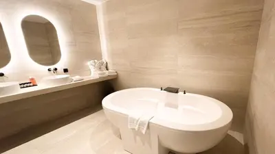 a bathroom with a white toilet and a sink at Van der Valk Hotel Houten Utrecht in Houten