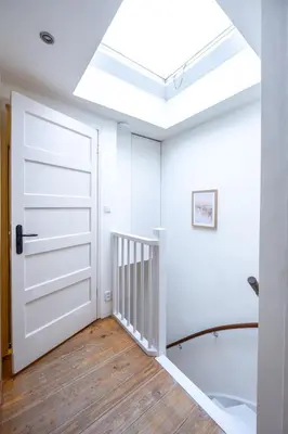 a room with a white door and a skylight at Beautiful Beach Holiday Home with Sauna and Garden in Wijk aan Zee