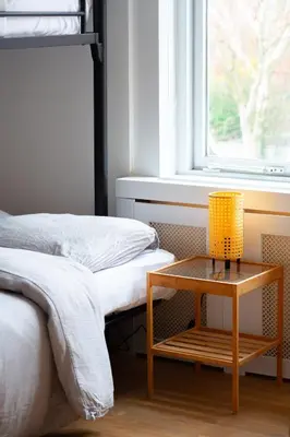 a room with two beds and a table next to a window at Beautiful Beach Holiday Home with Sauna and Garden in Wijk aan Zee