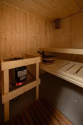 a small room with a stove in a sauna at Beautiful Beach Holiday Home with Sauna and Garden in Wijk aan Zee