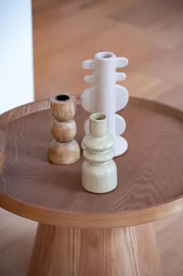 three white vases sitting on a wooden table at Beautiful Beach Holiday Home with Sauna and Garden in Wijk aan Zee