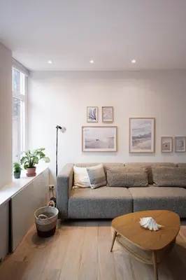 a living room with a couch and a table at Beautiful Beach Holiday Home with Sauna and Garden in Wijk aan Zee