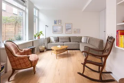 a living room with a couch and two chairs and a table at Beautiful Beach Holiday Home with Sauna and Garden in Wijk aan Zee