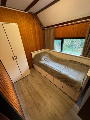 a small bedroom with a bed and a window at Lovely house till 9 pers near Amsterdam and the sea in Opmeer