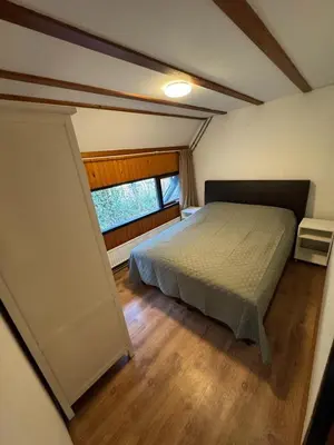 a bedroom with a bed and a window at Lovely house till 9 pers near Amsterdam and the sea in Opmeer