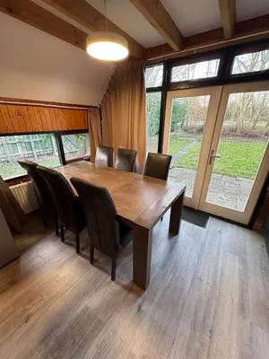 a dining room with a wooden table and chairs at Lovely house till 9 pers near Amsterdam and the sea in Opmeer