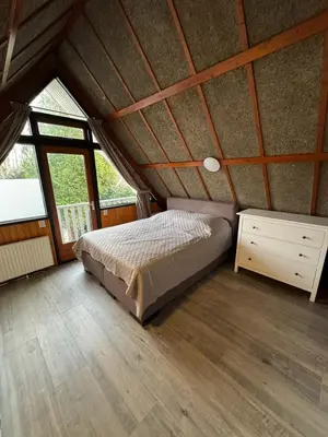 a bedroom with a bed in a attic at Lovely house till 9 pers near Amsterdam and the sea in Opmeer