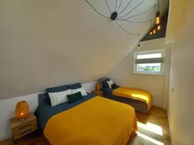 a bedroom with two beds and a window at Luxurious house close to the center of Amsterdam in Oostzaan