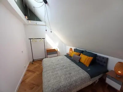 a bedroom with a bed with yellow pillows at Luxurious house close to the center of Amsterdam in Oostzaan