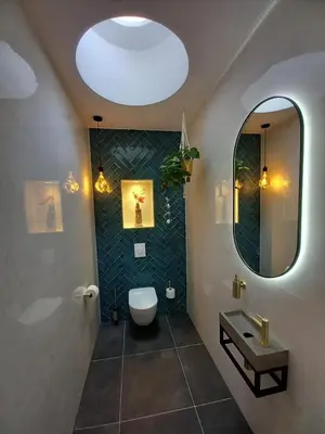 a bathroom with a toilet and a sink and a mirror at Luxurious house close to the center of Amsterdam in Oostzaan