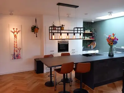 a kitchen with a table and chairs in a room at Luxurious house close to the center of Amsterdam in Oostzaan