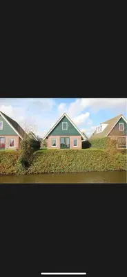 a group of houses in a yard with grass at Vakantiehuis Medemblik polder in Opperdoes