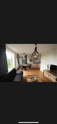 a living room with a couch and a table at Vakantiehuis Medemblik polder in Opperdoes