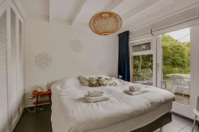 a bedroom with a bed with towels on it at Dutchen Vakantiepark Buiten Bergen in Schoorl