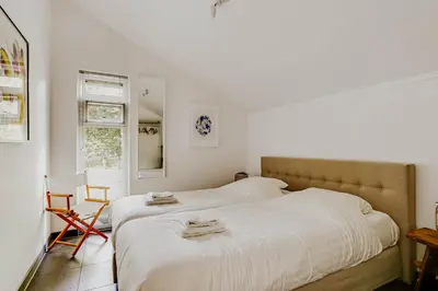 a bedroom with a bed with two towels on it at Dutchen Vakantiepark Buiten Bergen in Schoorl