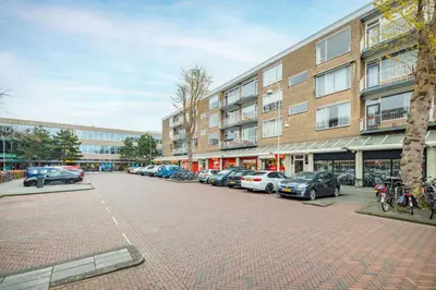 a parking lot with cars parked in front of a building at Stunning artist zen guest suite at heart of Amsterdam in Amsterdam