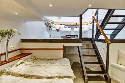 a bedroom with a bunk bed and a staircase at Your Houseboat Amsterdam in Amsterdam