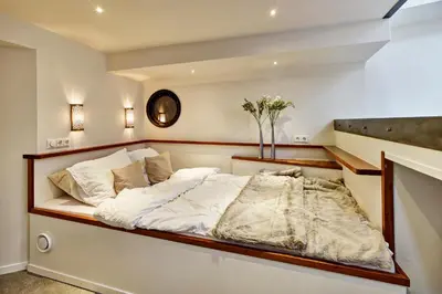 a bedroom with a large bed in a room at Your Houseboat Amsterdam in Amsterdam