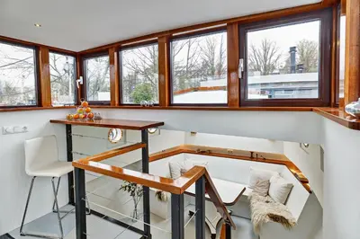 a home office with a desk and windows at Your Houseboat Amsterdam in Amsterdam