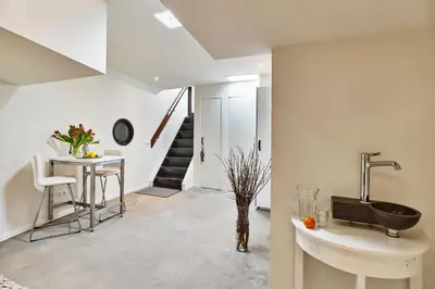 a bathroom with a sink and a table and a staircase at Your Houseboat Amsterdam in Amsterdam