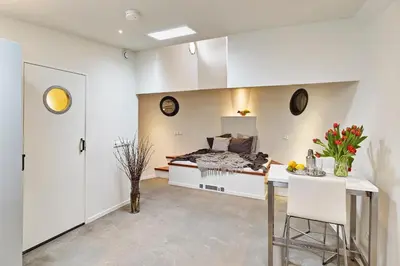 a bedroom with a bed and a table with flowers at Your Houseboat Amsterdam in Amsterdam