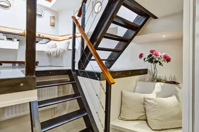 a staircase leading up to a tiny house at Your Houseboat Amsterdam in Amsterdam