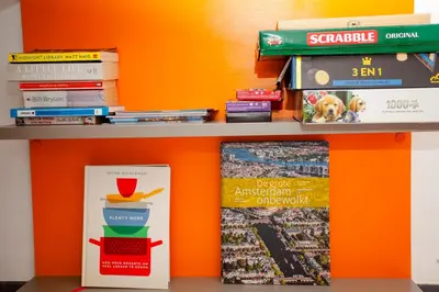 a book shelf with books and books at Modern Central Leiden Family Apt - Sleeps 6 and Baby in Leiden