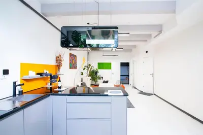 a kitchen with a sink and a tv on the ceiling at Modern Central Leiden Family Apt - Sleeps 6 and Baby in Leiden