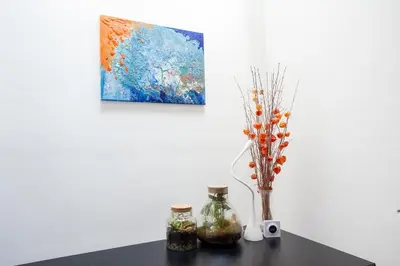 a table with two bottles and a vase with a painting at Modern Central Leiden Family Apt - Sleeps 6 and Baby in Leiden