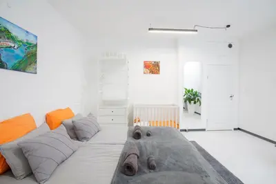 a living room with a large bed in the middle at Modern Central Leiden Family Apt - Sleeps 6 and Baby in Leiden