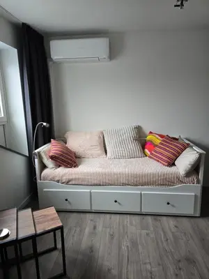 a couch with pillows on it in a room at Studio Amnesia in Heerhugowaard