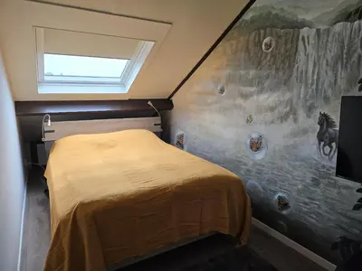 a bedroom with a horse painting on the wall at Studio Amnesia in Heerhugowaard