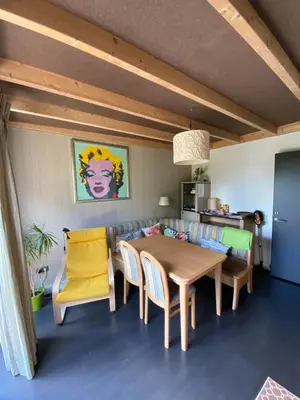 a dining room with a table and chairs at T kan Verkeren - Houseboat in Amsterdam