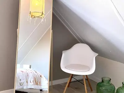 a white chair sitting in front of a mirror at Stunning villa near beaches and golf course in Sint Maarten