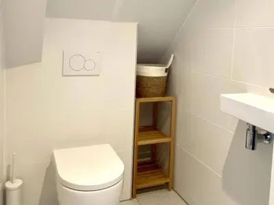 a small bathroom with a toilet and a sink at Stunning villa near beaches and golf course in Sint Maarten