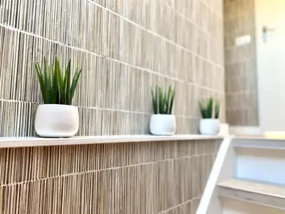 three plants in white pots on a wall at Stunning villa near beaches and golf course in Sint Maarten