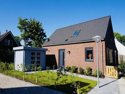 a brick house with a black roof at Beautiful Villa close to beaches in Sint Maarten