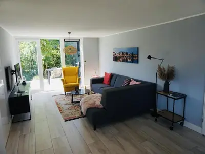 a living room with a couch and a chair at Beautiful Villa close to beaches in Sint Maarten