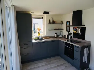 a kitchen with blue cabinets and a window at Beautiful Villa close to beaches in Sint Maarten